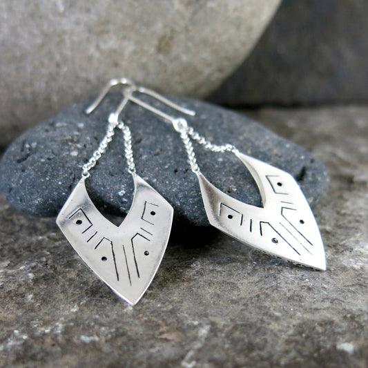 Angular geometric Aja Drop Earrings in silver-plated brass with sterling silver chains and hooks, showcasing etched linear patterns. 